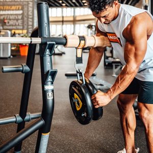 man loading plates on anchor loader at bench