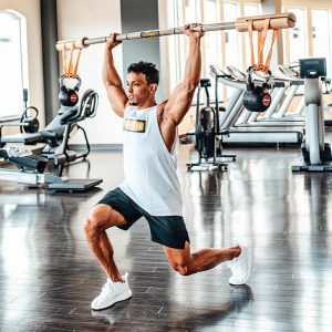 man lunging with bamboo bar overhead