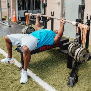 man benching with loaded earthquake bar