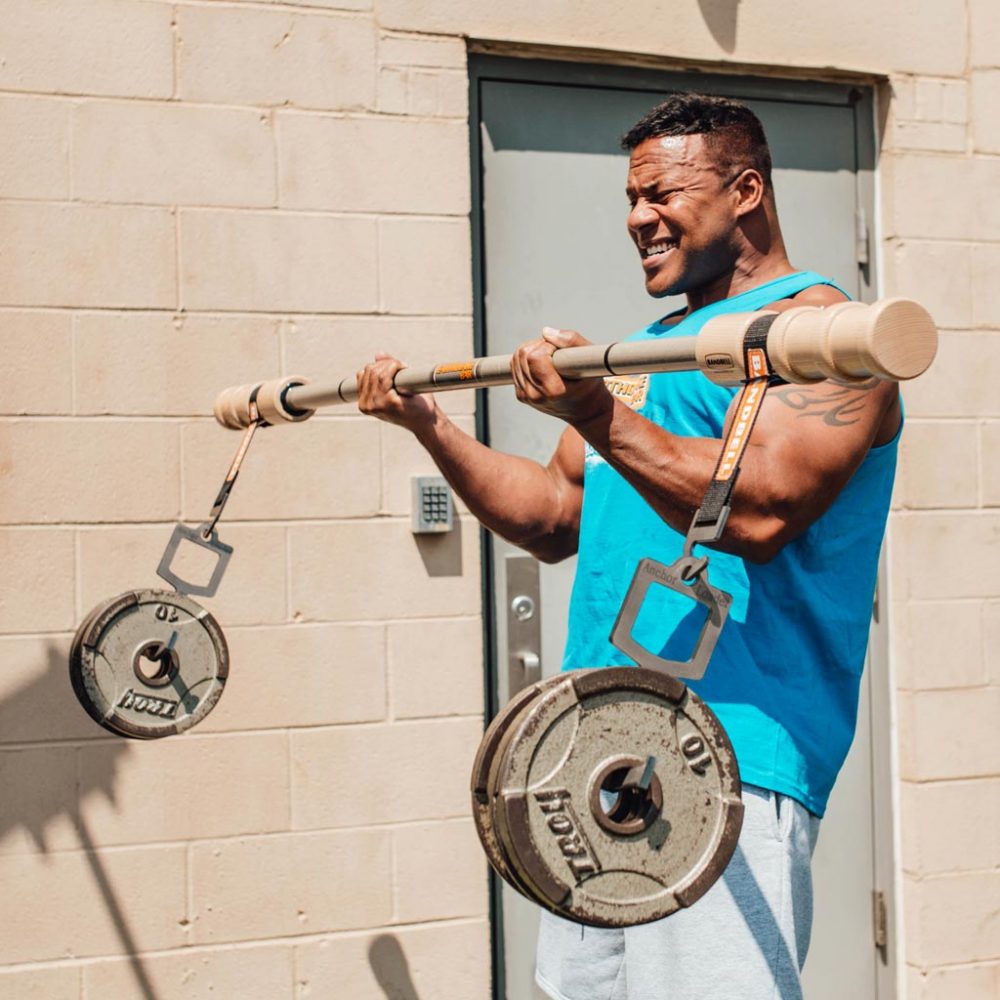 man curling weight with earthquake bar