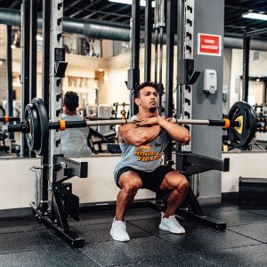 man front squatting with rhino flex bar