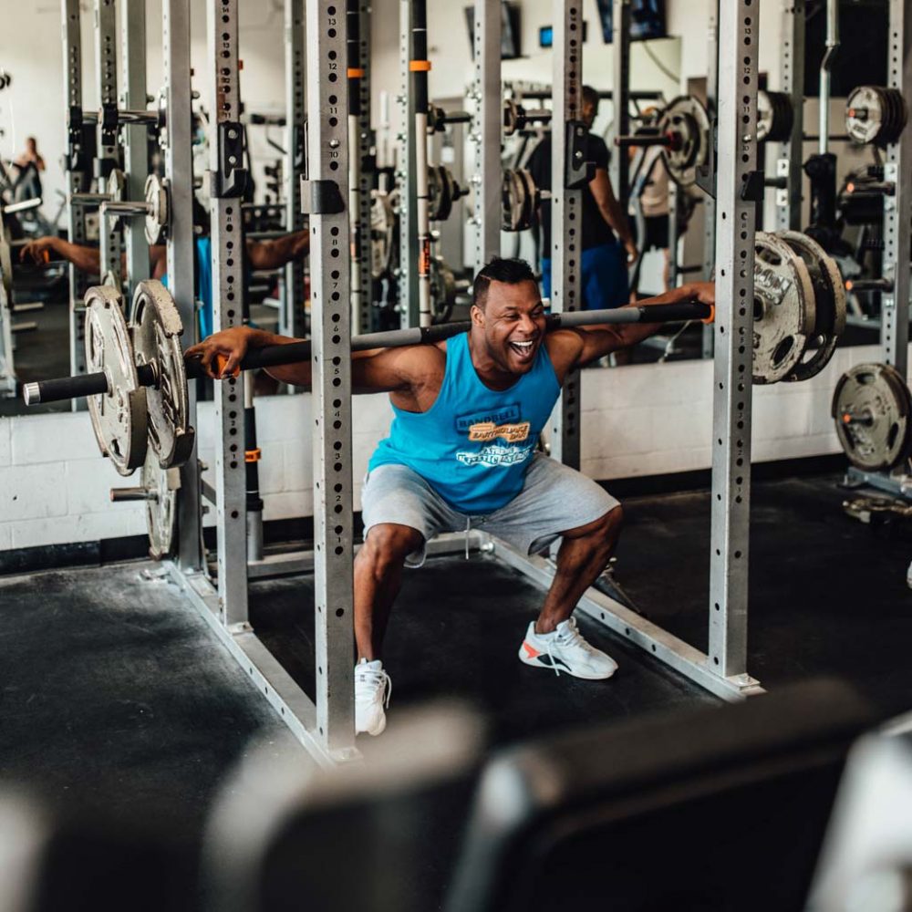 man squatting with super rhino bar